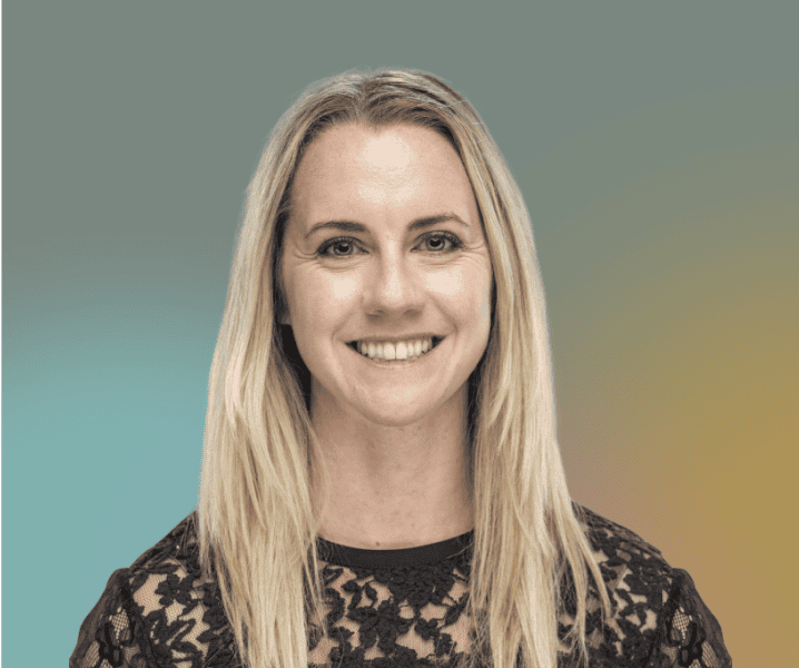Dayna McCutchin, a woman with long blonde hair wearing a black lace top, smiles at the camera against a gradient background.
